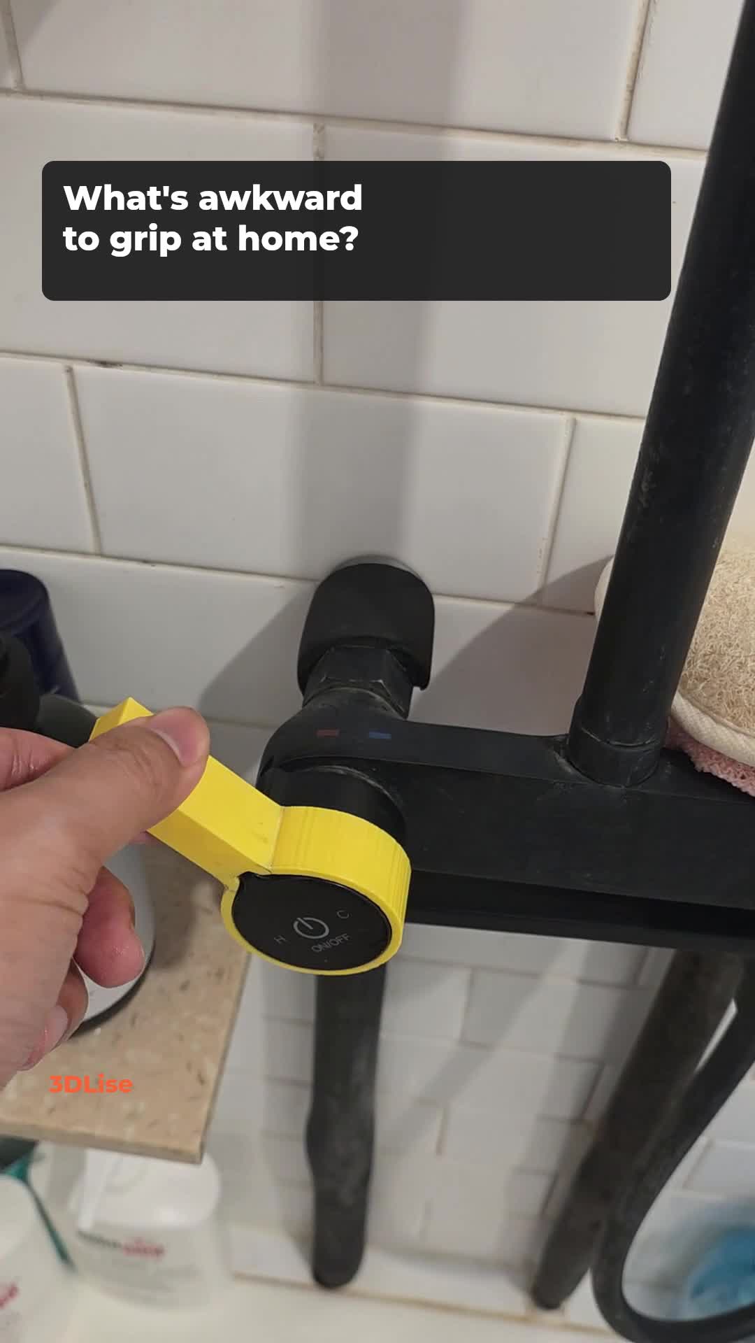A yellow printed grip adapter fitted to a shower knob